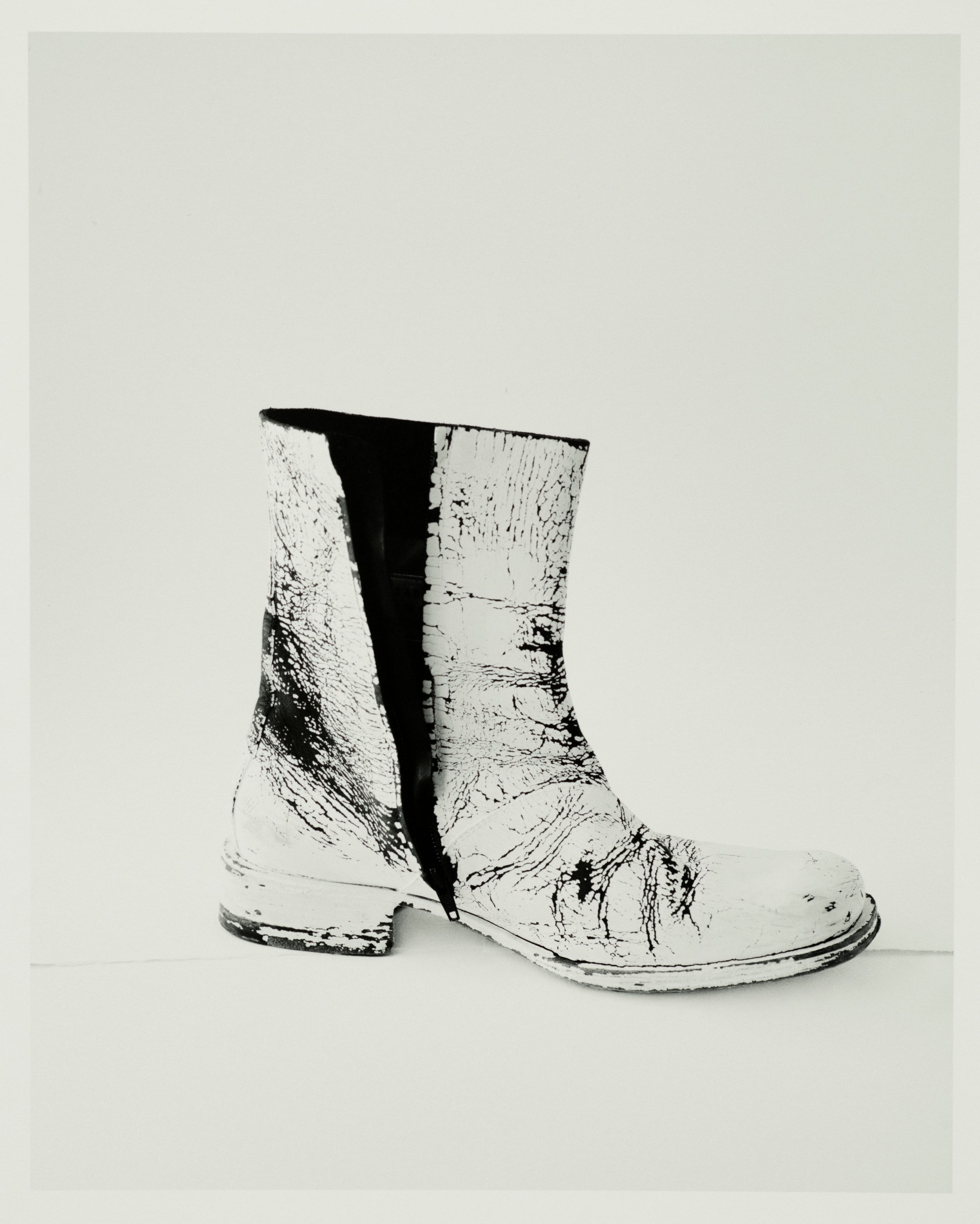 Vintage boots by Maison Martin Margiela, Spring 1999, from Artifact. Having first appeared as a prototype at the Spring 1999 show, these boots, with their cracked paint finish, reflect Martin Margiela’s deconstructionist approach. The designer avoided interviews about his collections to allow room for multiple interpretations.