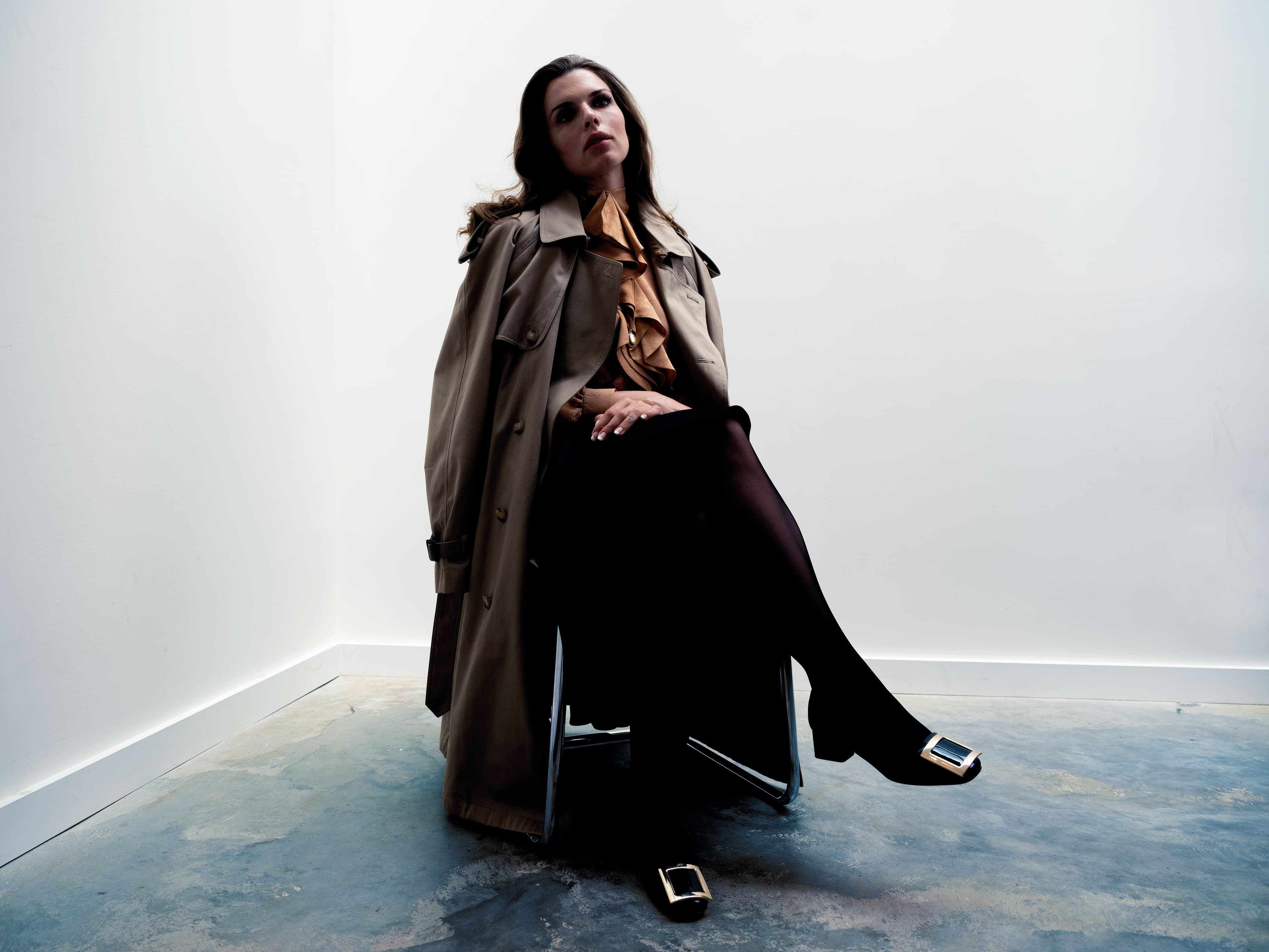 Trench coat, stylist’s own. Shirt by Gucci. Skirt by Lafayette 148. Hosiery by Wolford. Shoes by Roger Vivier. Necklace by Monica Rich Kosann.