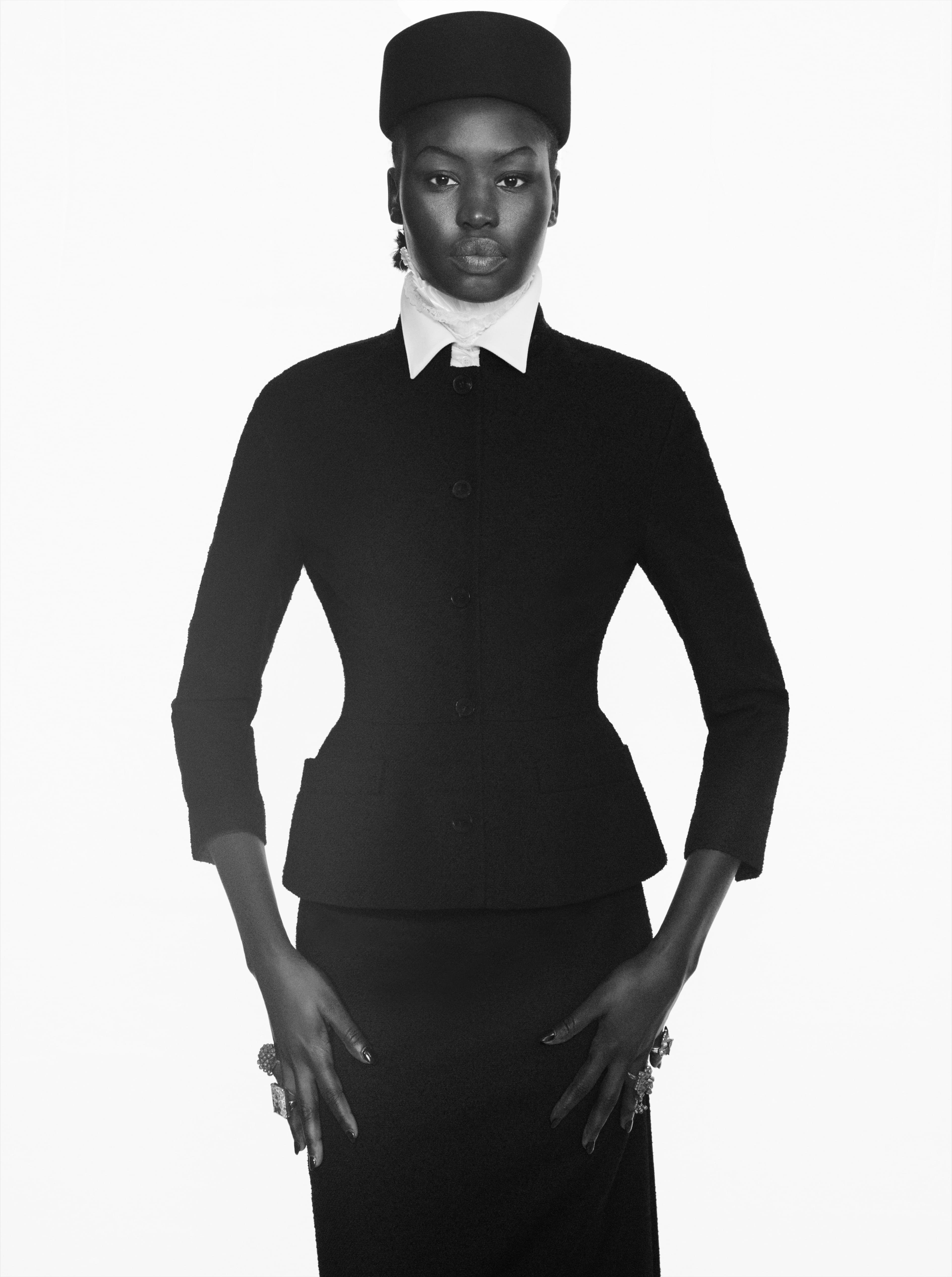 JACKET and SKIRT by ,Dior., SHIRT by ,Ashlyn., HAT by ,Alaïa., Vintage RINGS from David Aliperti Archive.