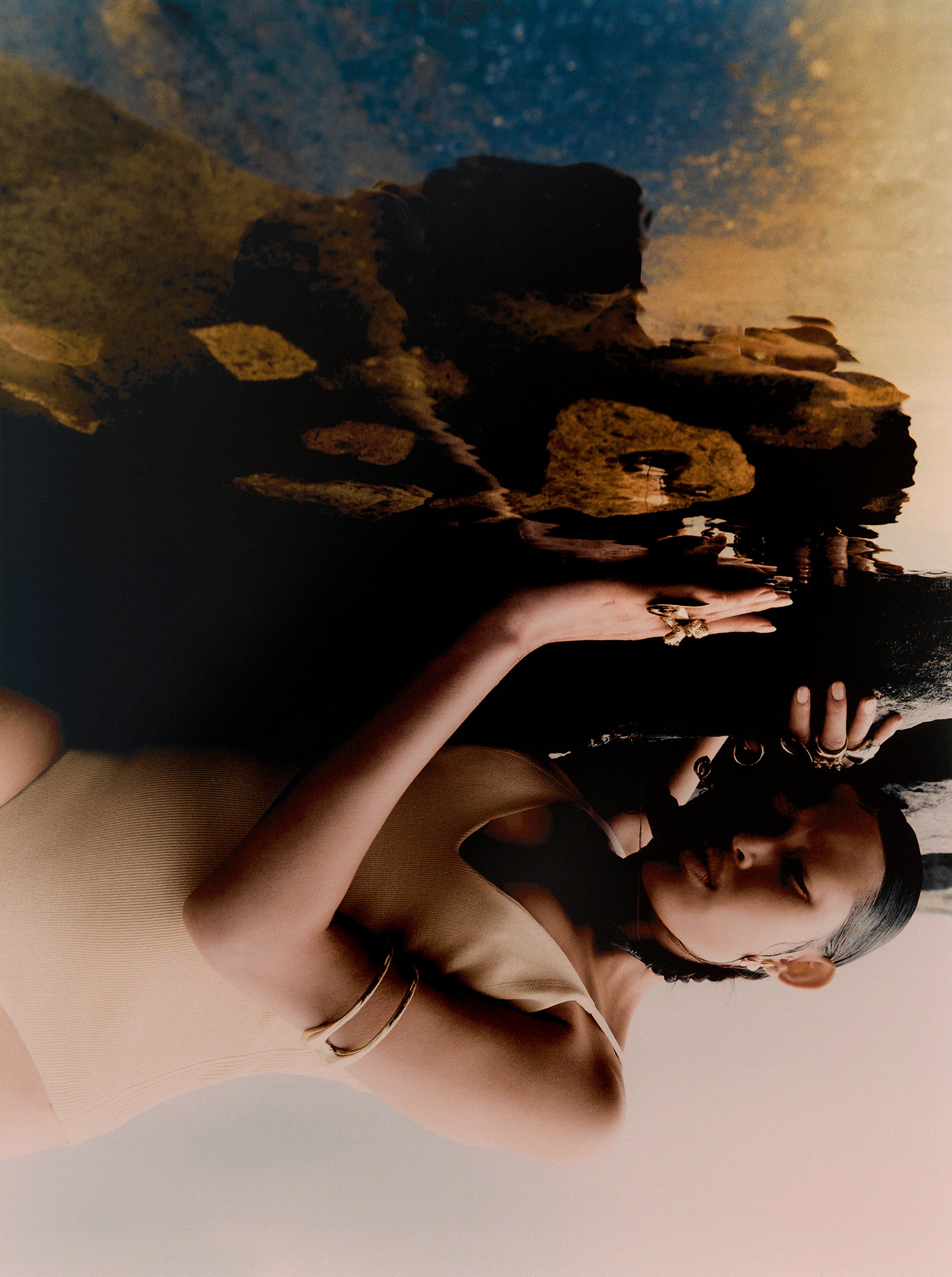 Swimsuit by Sir The Label. Arm cuff by Christopher Esber. Earrings by Jordan Askill. All rings by Dinosaur Designs.