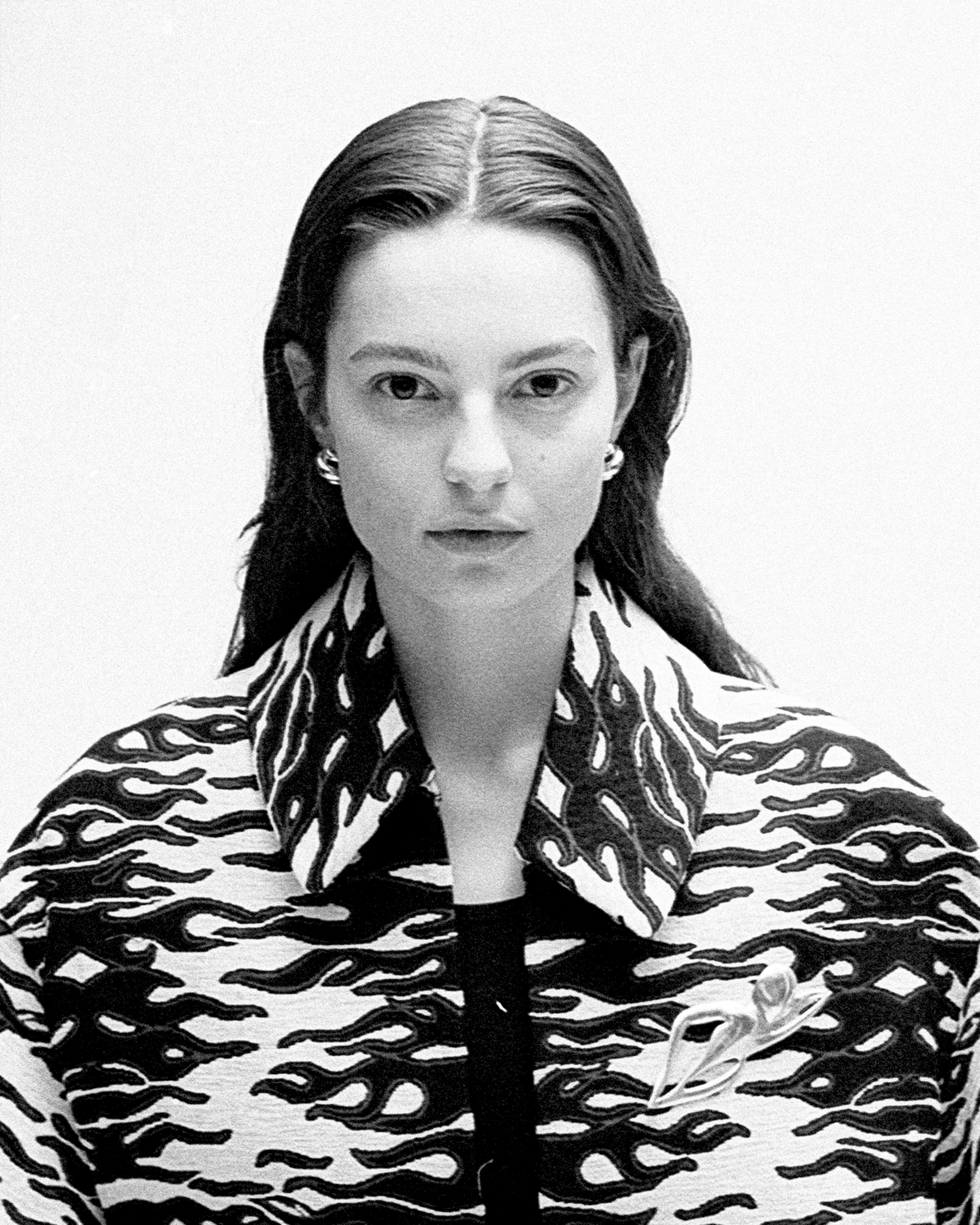 Model Emily Statkun in a fashion spread featuring brands such as Loewe, Ferragamo, Issey Miyake, and Ashlyn.