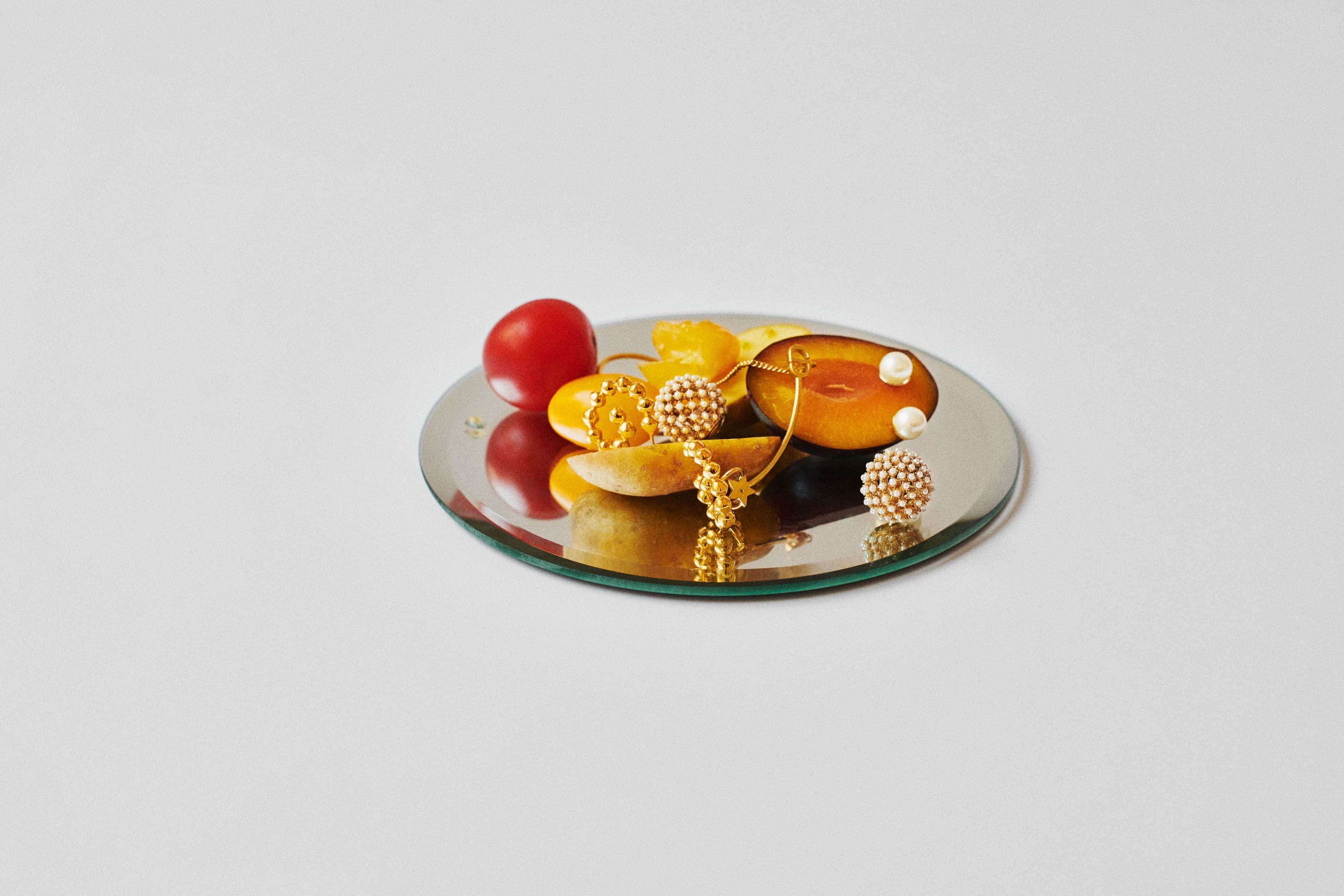 Ball earrings and studs by Christian Dior. Hoop earrings by Patcharavip.