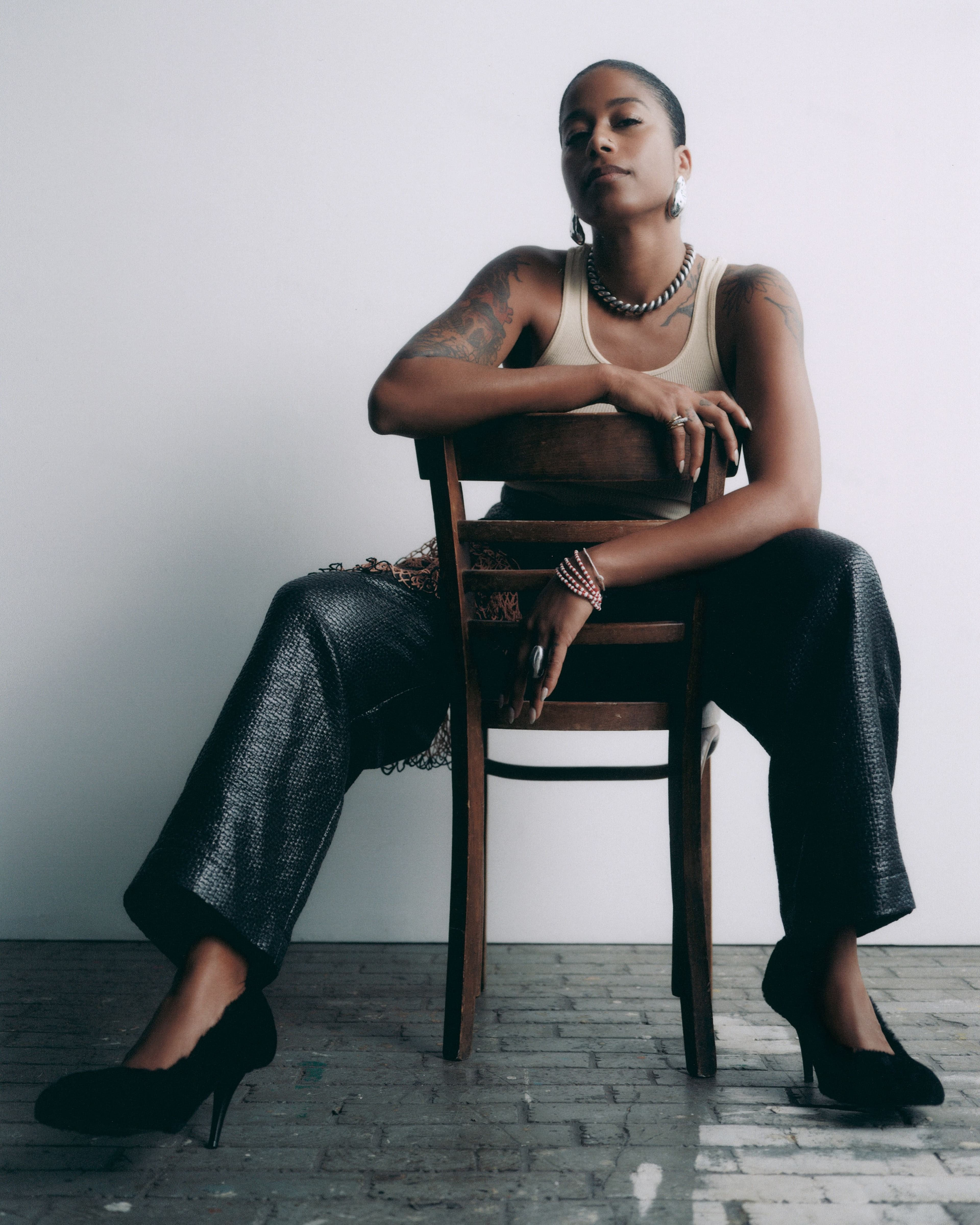 Top, stylist’s own. Pants by Diotima. Shoes by Stella McCartney. All jewelry by Alexis Bittar.