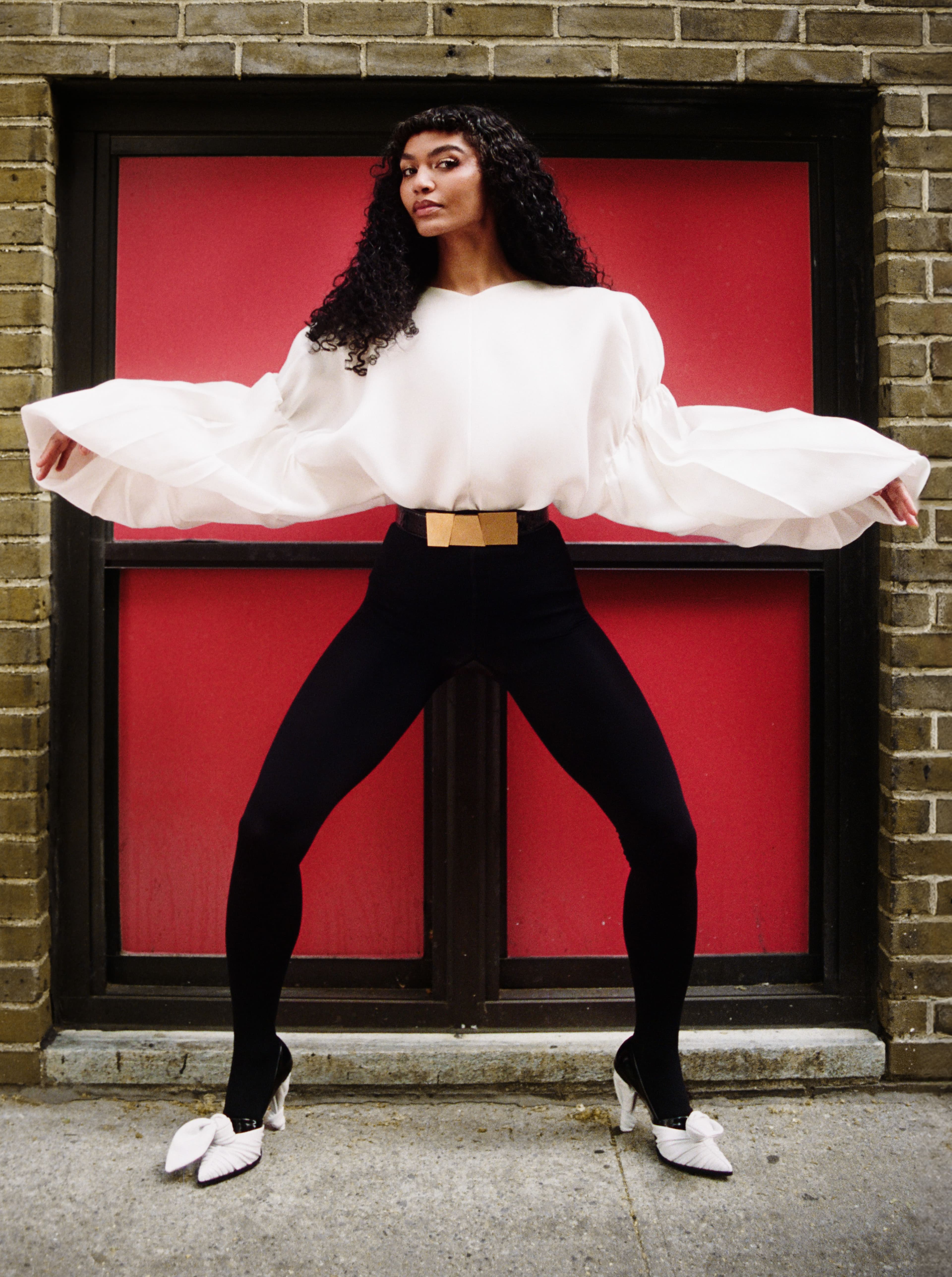 TOP and BELT by ,Khaite. ,TIGHTS by ,Wolford. ,SHOES by ,Louis Vuitton.