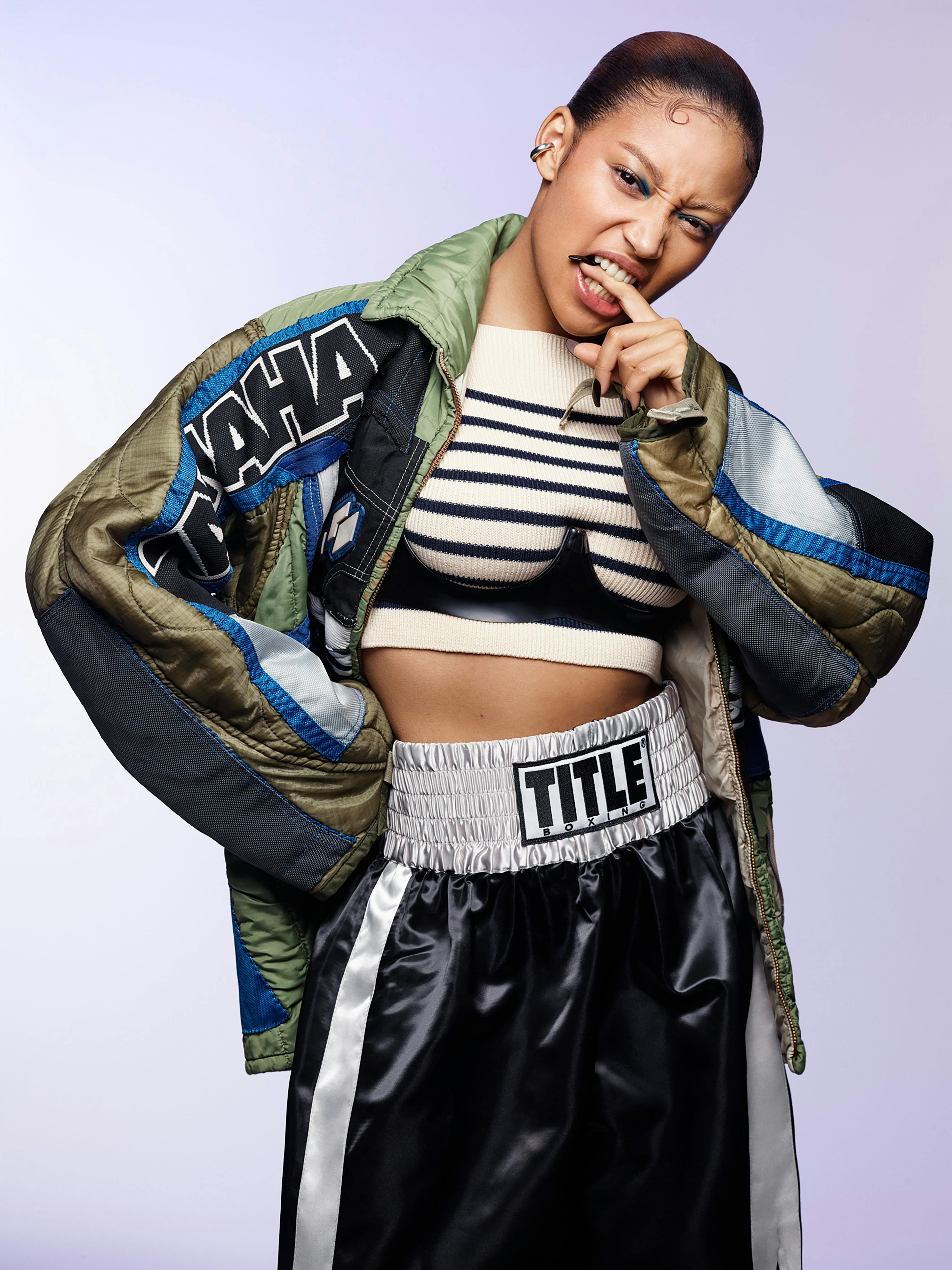 Jacket by Courtney MC. Bra by Atusko Kudo. Vintage top by Jean Paul Gaultier from the Albright Fashion Library. Vintage shorts by Title Boxing from the David Casavant Archive. Ear cuff by All Blues.